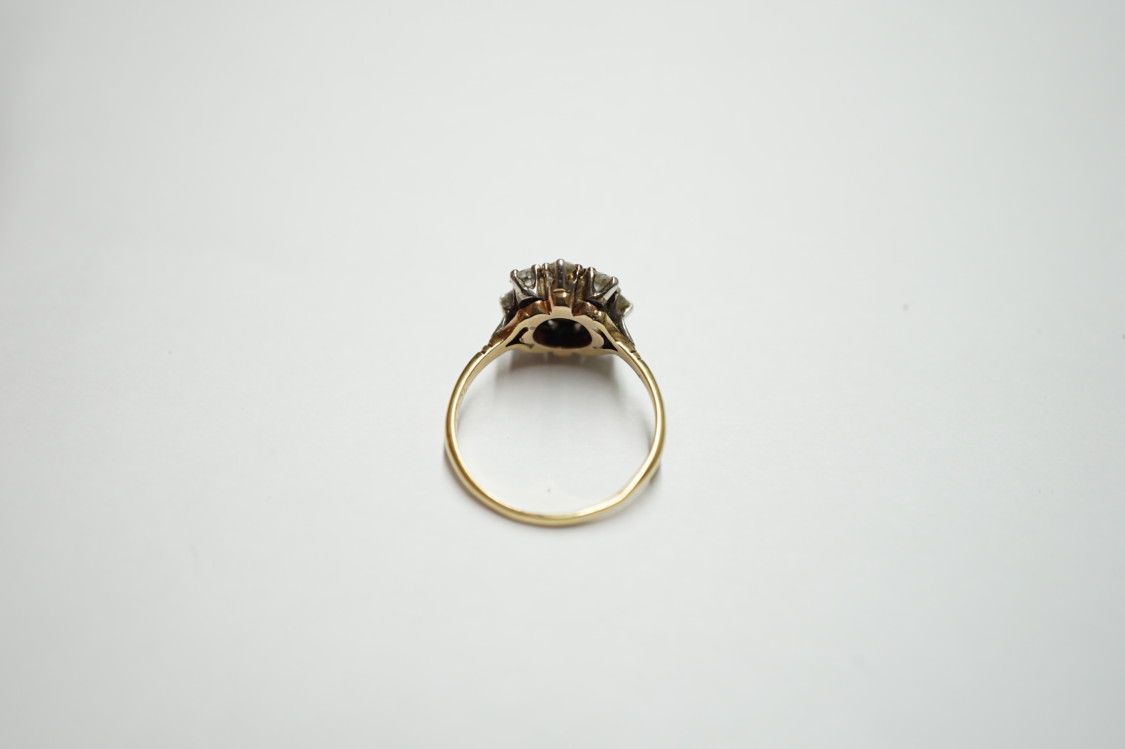 An 18ct gold, sapphire and diamond set flower head cluster ring, size O, gross weight 3.8 grams. Condition - fair